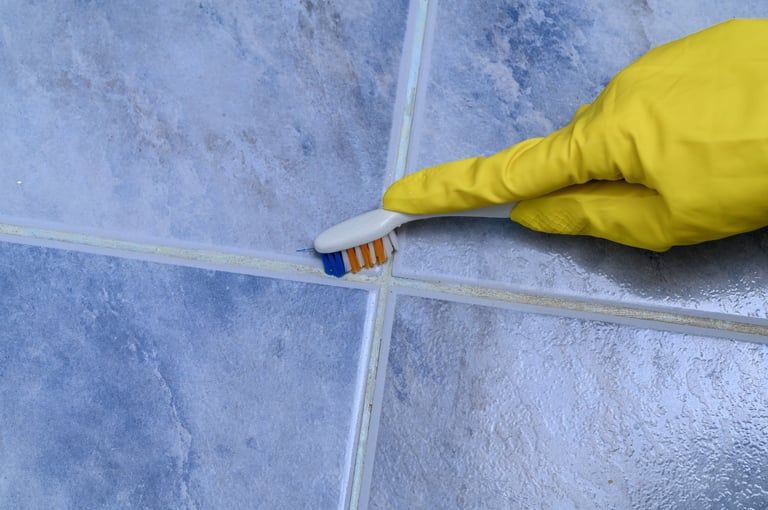 Precise scrubbing of dirty joints between tiles on the floor — VA grout cleaning