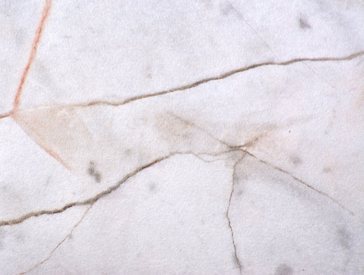 Close-up of cracked marble surface showing damage that requires professional repair in Raleigh NC