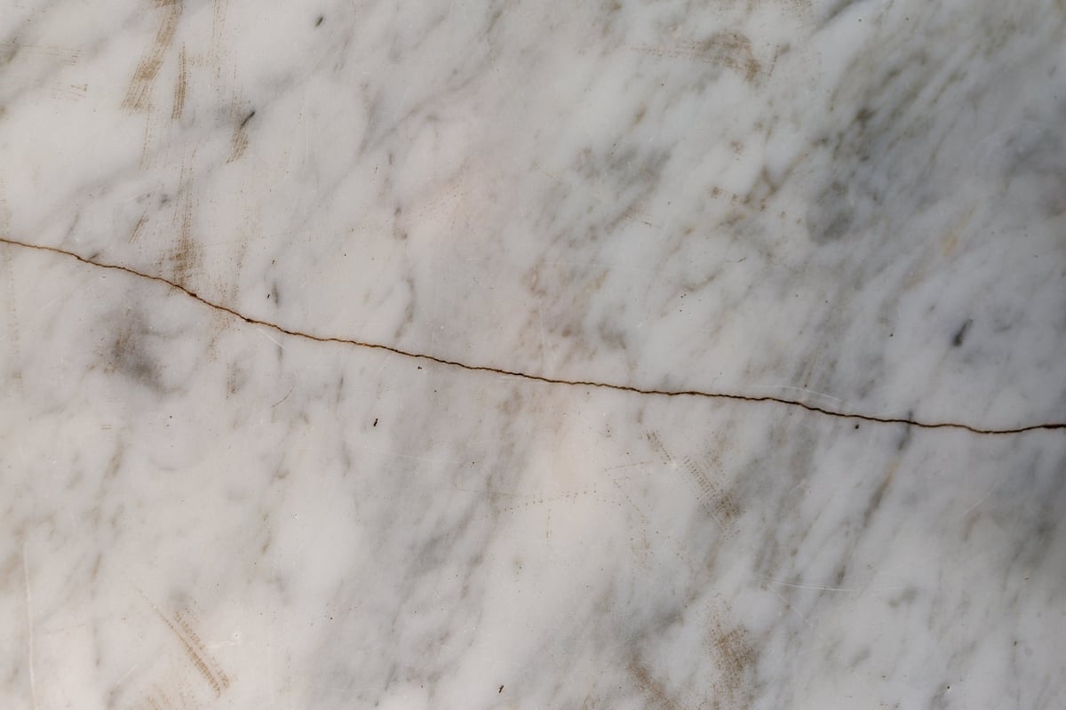 Damaged marble countertop surface with etching and visible cracking in Raleigh NC