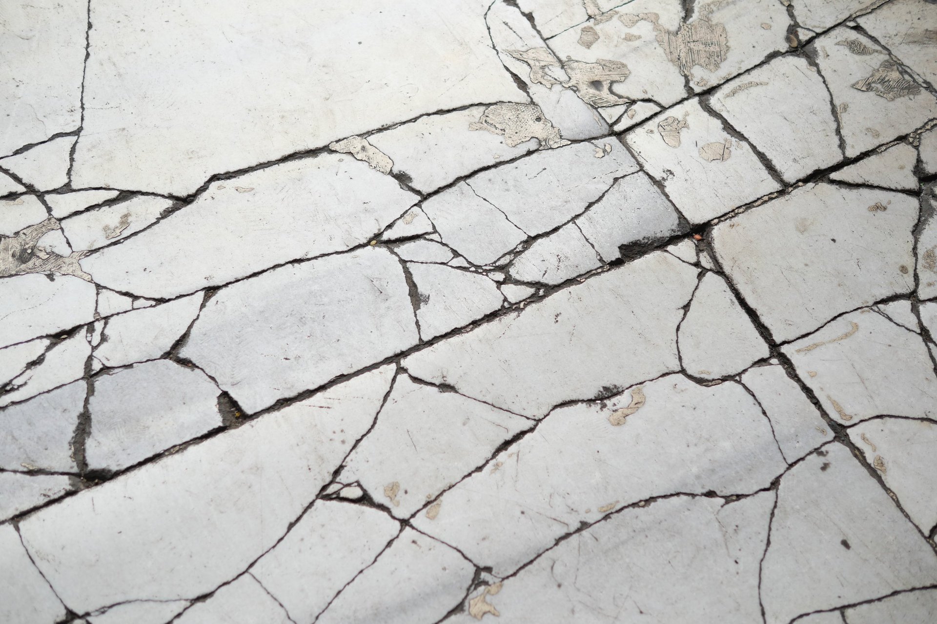 Close view of a marble floor with cracks and signs of aging before professional marble repair in Virginia