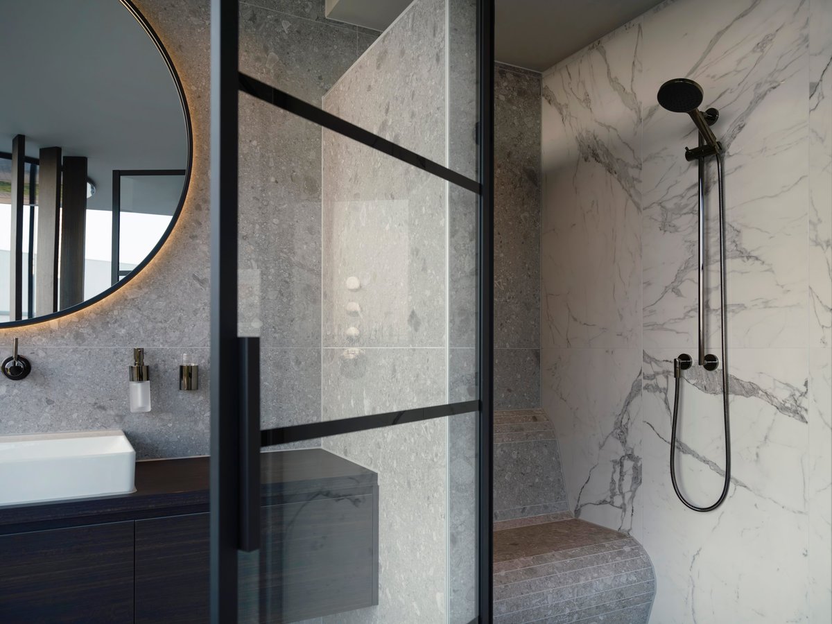 Luxury marble shower with glass enclosure in a Raleigh NC bathroom
