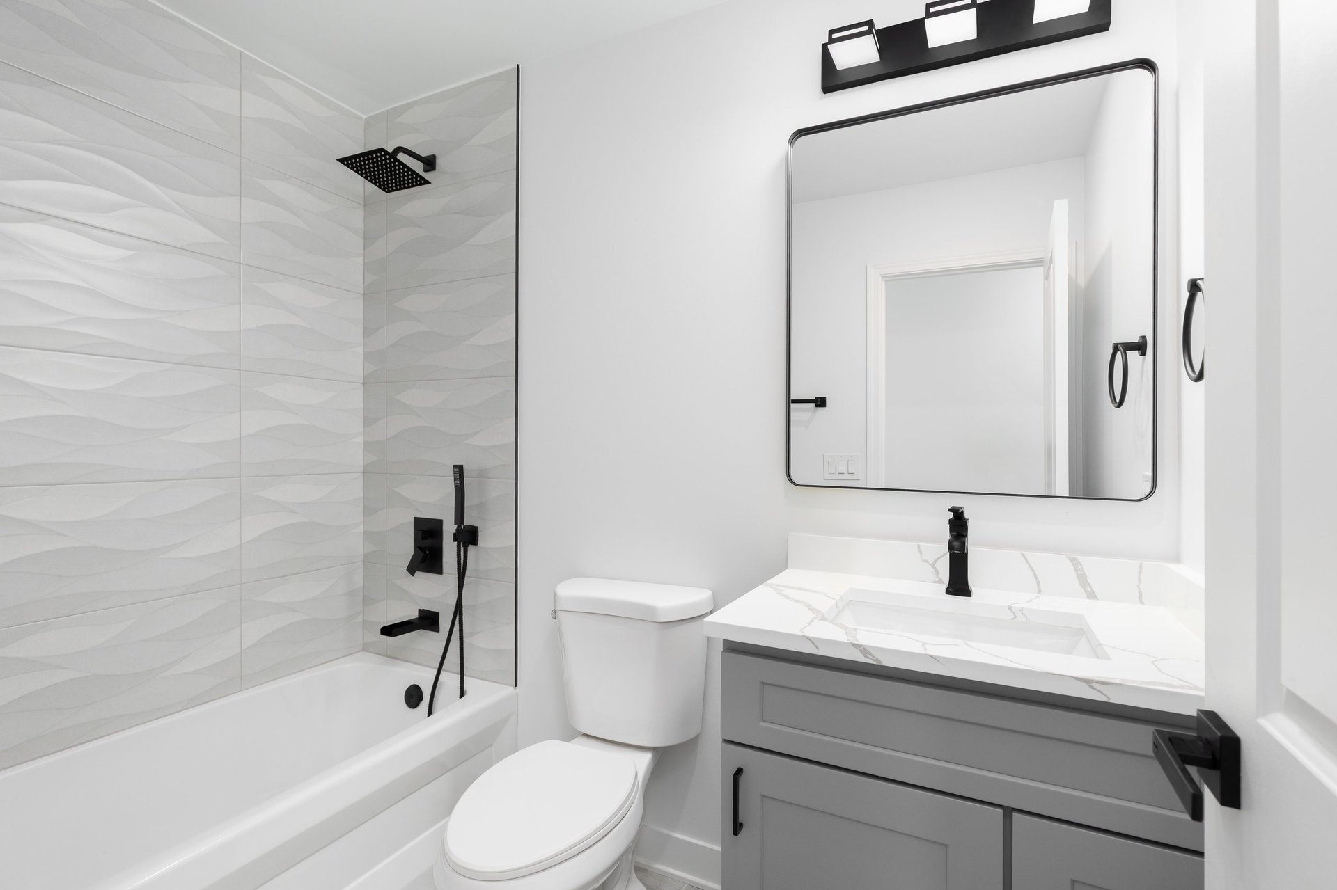 Modern Virginia bathroom with polished white marble vanity countertop after repair
