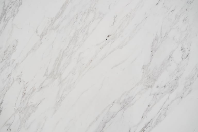 Close-up of a beautifully polished white marble surface with natural gray veining