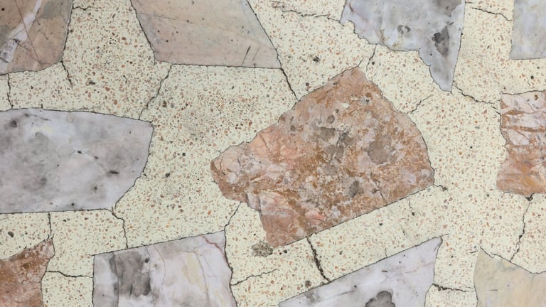 Weathered marble countertop with hairline cracks and dull spots before polishing